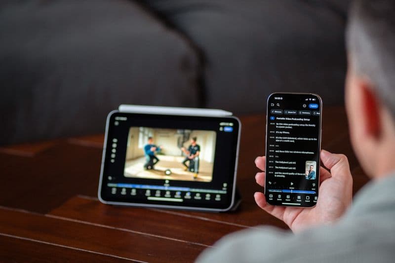A person accessing media on a tablet and smartphone